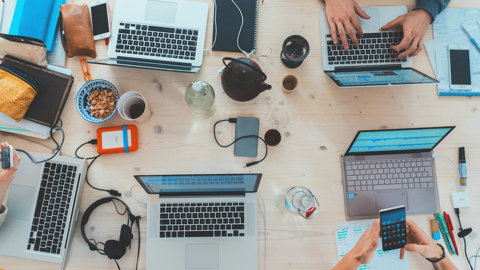 Team collaborating around laptops in a modern workspace