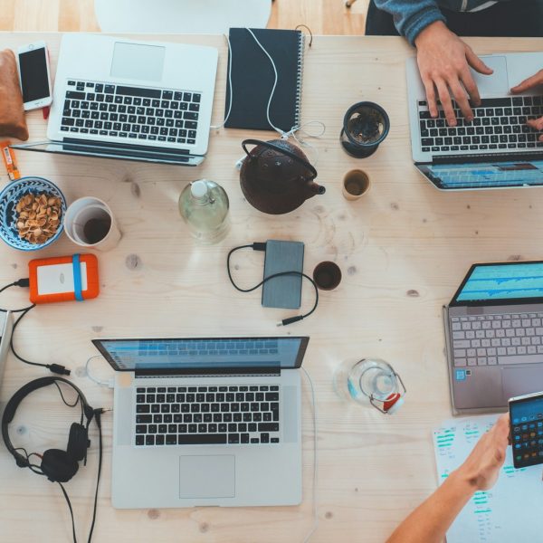 Team collaborating around laptops in a modern workspace