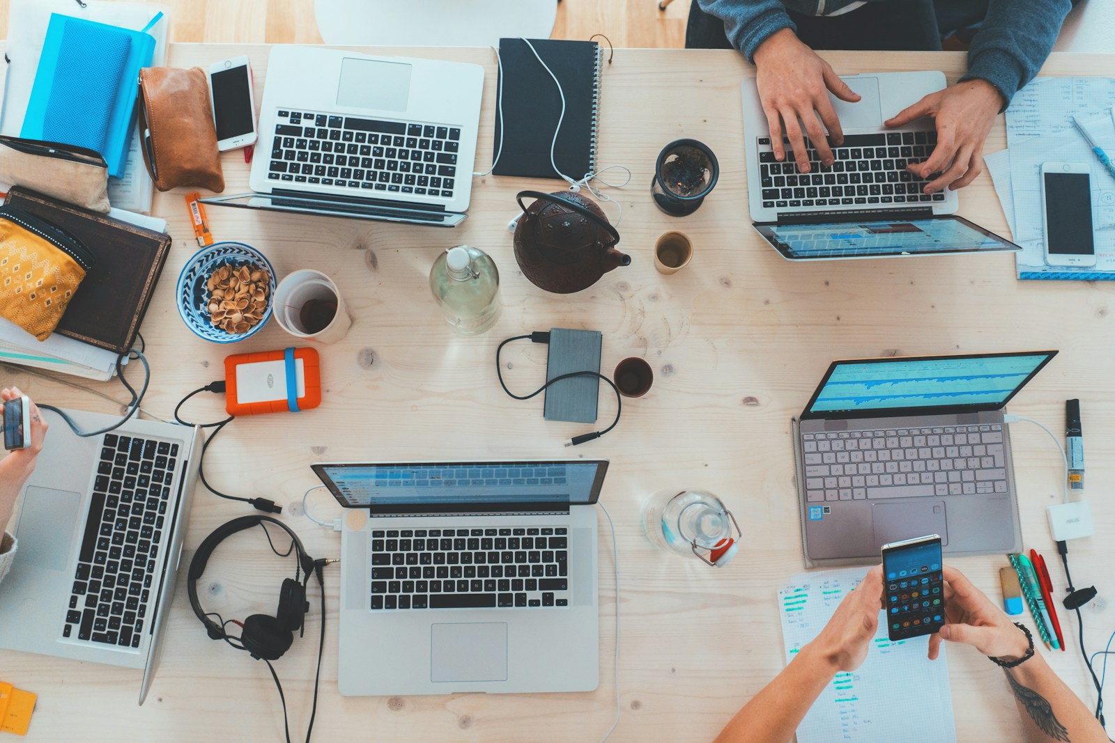 Team collaborating around laptops in a modern workspace